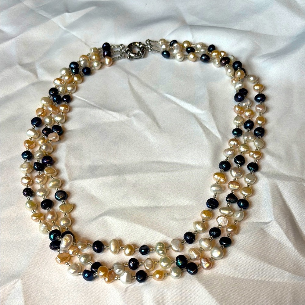 3-strand baroque pearl necklace in white, blue, cream.